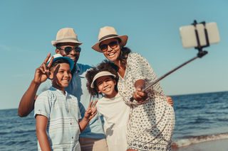 Family taking a selfie on the beach